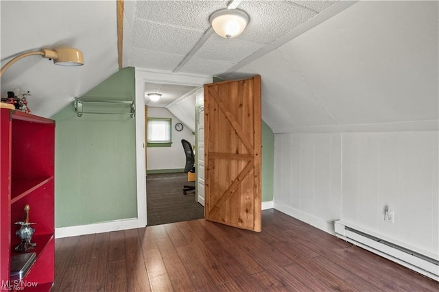 additional living space featuring baseboards, a baseboard radiator, wood finished floors, and lofted ceiling
