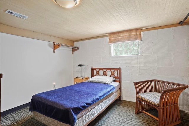 bedroom featuring visible vents and hardwood / wood-style floors