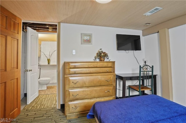 bedroom featuring visible vents, wooden ceiling, and ensuite bath