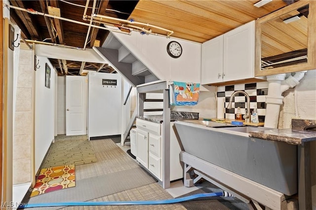 interior space with white cabinetry and dark countertops