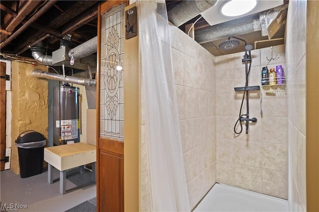 bathroom featuring water heater, a tile shower, and concrete floors