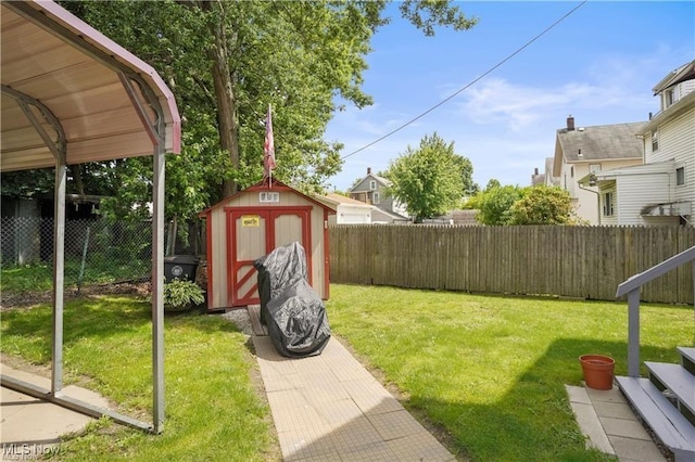 view of yard featuring an outbuilding, a fenced backyard, and a storage unit