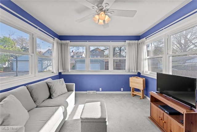 sunroom with a healthy amount of sunlight, carpet floors, baseboards, and visible vents
