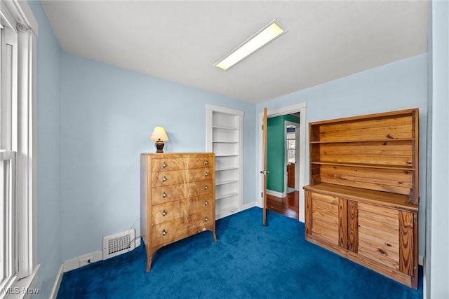bedroom featuring baseboards, visible vents, and carpet