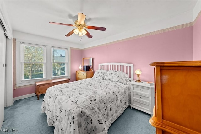 carpeted bedroom with baseboards and a ceiling fan