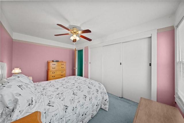 bedroom featuring a ceiling fan, carpet, and a closet