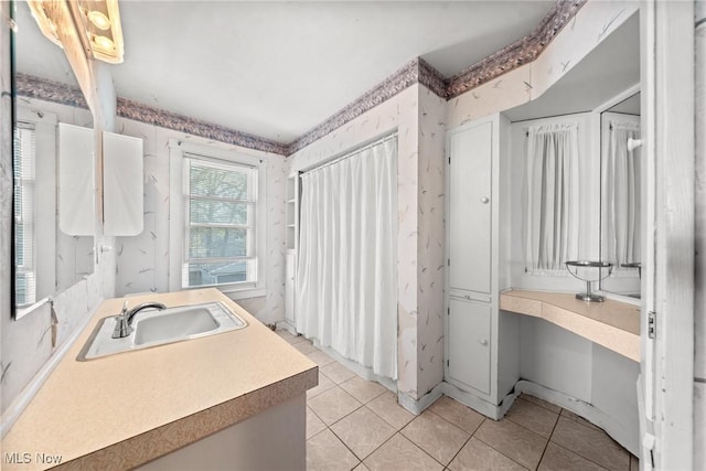 bathroom with vanity, tile patterned flooring, and wallpapered walls