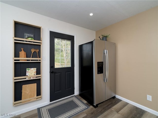 doorway featuring baseboards, recessed lighting, and dark wood-style floors