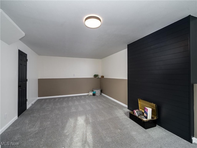 interior space featuring carpet floors and baseboards