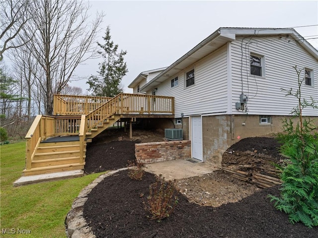 back of property featuring stairway, a wooden deck, and central AC unit