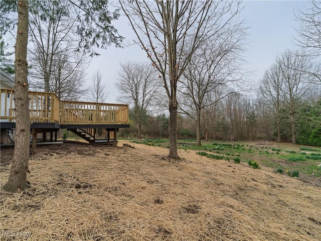 view of yard featuring stairway and a deck
