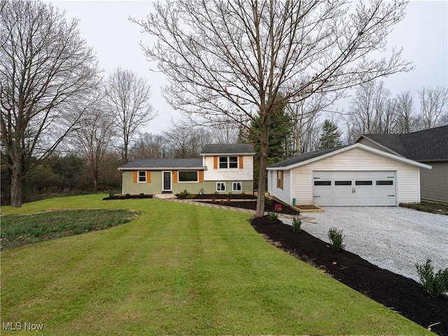 tri-level home featuring a garage, an outbuilding, and a front yard