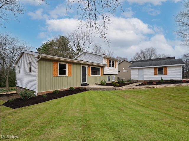 tri-level home featuring board and batten siding and a front yard