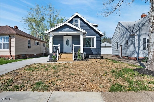 4394 W 139th St, Cleveland, OH 44135 - bungalow-style home featuring a garage, an outbuilding, and a porch