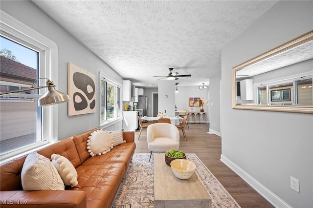4394 W 139th St, Cleveland, OH 44135 - living area featuring baseboards, a textured ceiling, ceiling fan, and wood finished floors