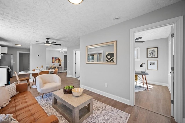 4394 W 139th St, Cleveland, OH 44135 - living area featuring baseboards, a ceiling fan, a textured ceiling, and wood finished floors