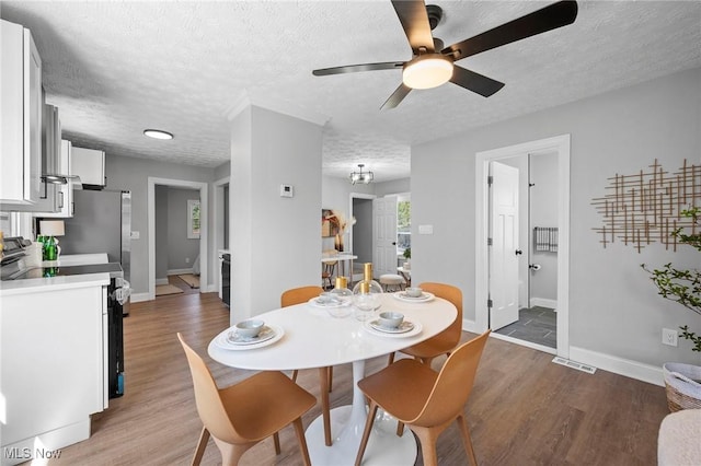 4394 W 139th St, Cleveland, OH 44135 - dining room with a textured ceiling, a ceiling fan, wood finished floors, and visible vents