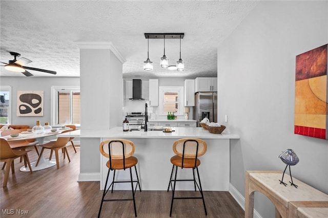 4394 W 139th St, Cleveland, OH 44135 - kitchen with wall chimney range hood, a sink, a textured ceiling, dark wood-type flooring, and stainless steel refrigerator with ice dispenser
