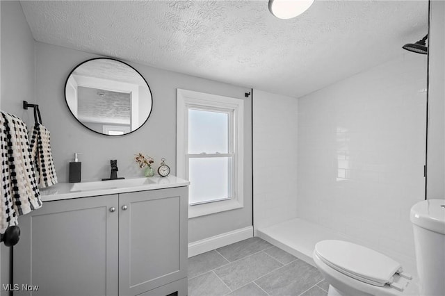 4394 W 139th St, Cleveland, OH 44135 - full bathroom featuring vanity, tile patterned flooring, toilet, a textured ceiling, and a tile shower