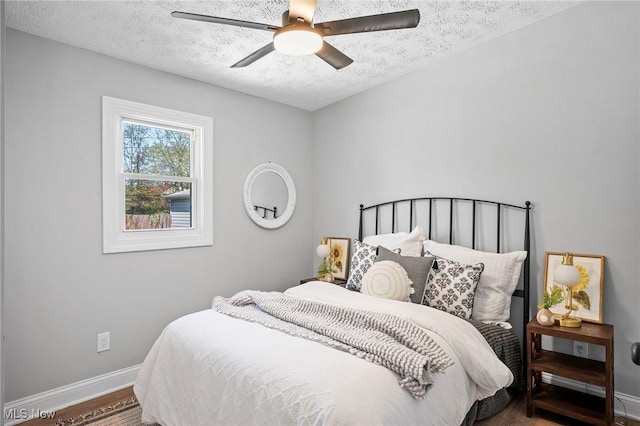 4394 W 139th St, Cleveland, OH 44135 - bedroom featuring baseboards, a textured ceiling, ceiling fan, and wood finished floors