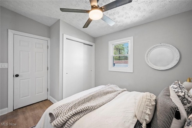 4394 W 139th St, Cleveland, OH 44135 - bedroom with a closet, wood finished floors, baseboards, a textured ceiling, and a ceiling fan