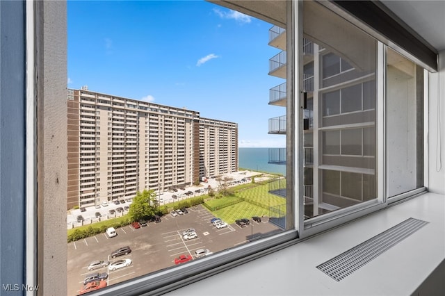 balcony featuring visible vents and a water view