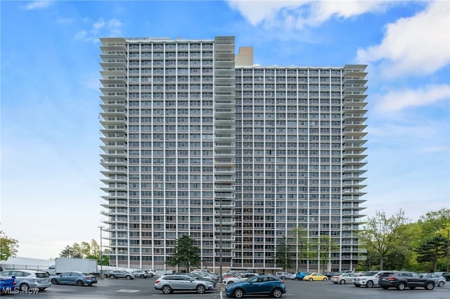 view of building exterior with uncovered parking
