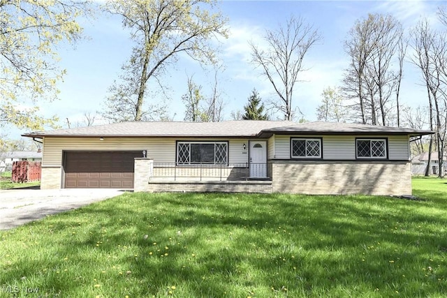 ranch-style home featuring an attached garage, a front lawn, driveway, and brick siding