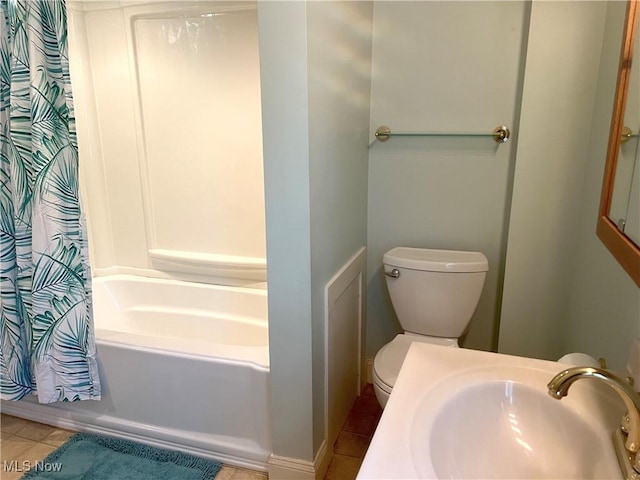 bathroom with a sink, tile patterned flooring, toilet, and shower / bathtub combination with curtain