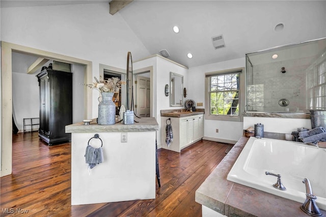 kitchen featuring dark wood-style flooring, recessed lighting, baseboards, vaulted ceiling with beams, and visible vents