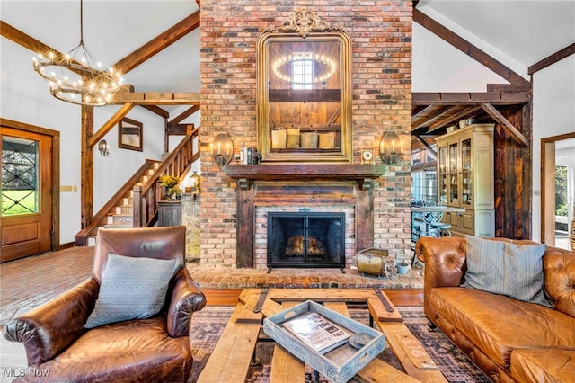 living room with beamed ceiling, high vaulted ceiling, a chandelier, and a brick fireplace