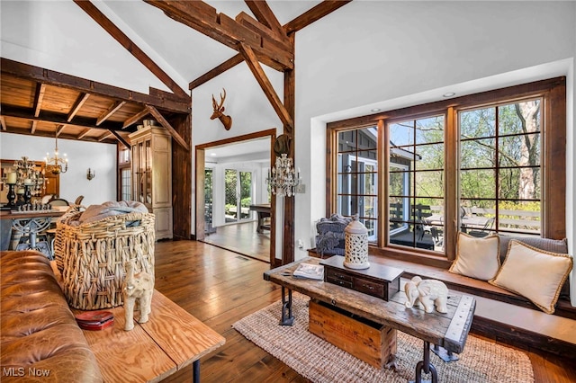 living room with high vaulted ceiling, a notable chandelier, beam ceiling, and hardwood / wood-style flooring