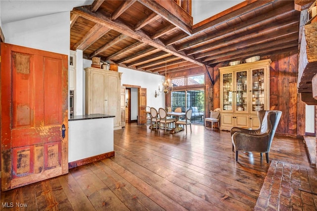 foyer with wood ceiling, dark wood finished floors, and beamed ceiling