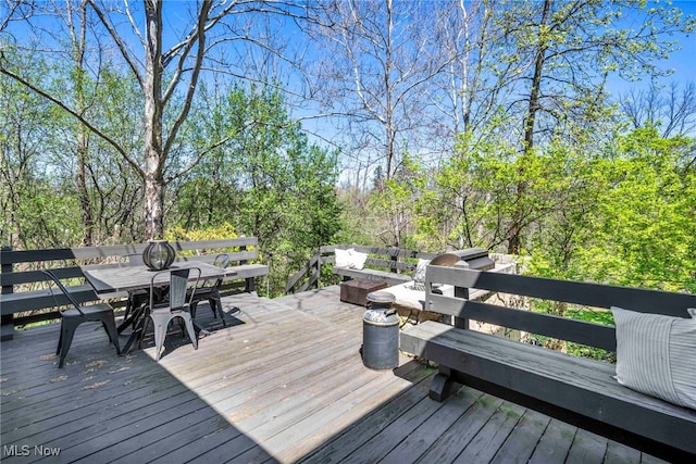 wooden deck featuring outdoor dining area