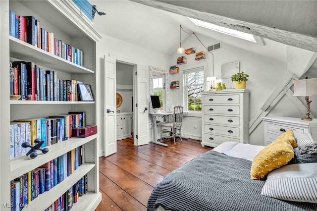 bedroom featuring vaulted ceiling with skylight, hardwood / wood-style floors, and visible vents
