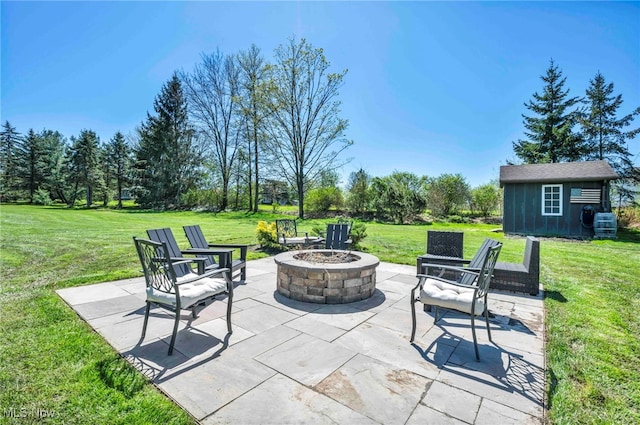 view of patio featuring a fire pit and an outbuilding