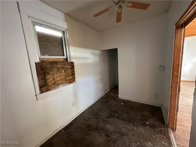 corridor featuring baseboards and visible vents