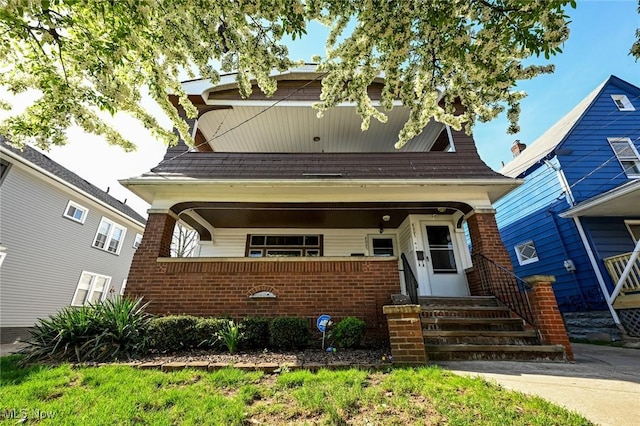view of front of house with covered porch and brick siding