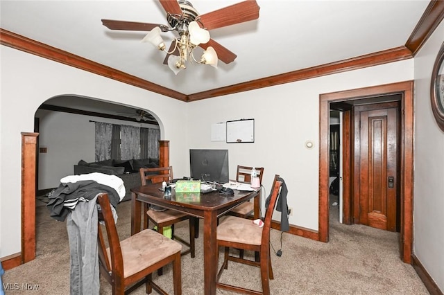 dining area with arched walkways, baseboards, light colored carpet, and ornamental molding