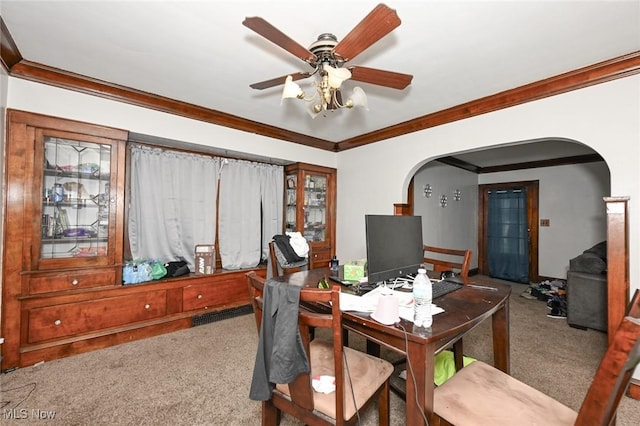 office space featuring crown molding, arched walkways, and carpet