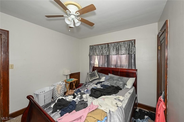 bedroom with a ceiling fan and baseboards
