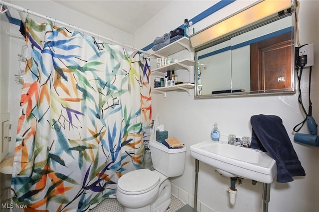 bathroom featuring toilet and a shower with curtain