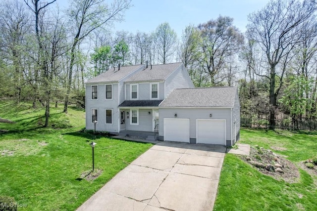 view of front of property featuring a garage, driveway, and a front yard