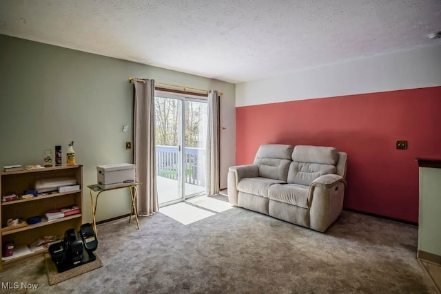 sitting room with carpet floors and a textured ceiling