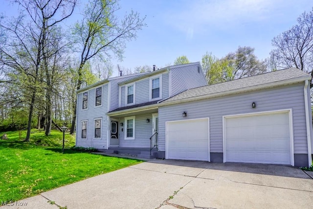 view of front of home with concrete driveway, an attached garage, and a front lawn