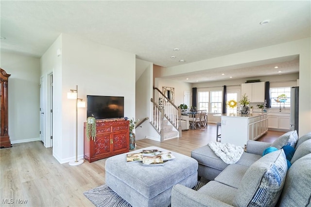 1662 N Eckert Ln, Akron, OH 44313 - living area with baseboards, stairway, light wood-style flooring, and recessed lighting