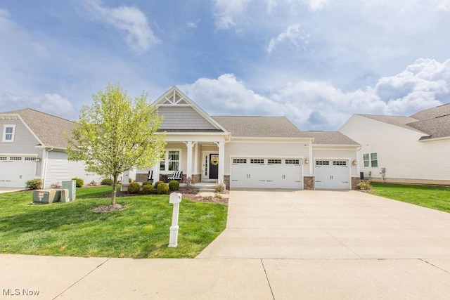 craftsman inspired home featuring a front lawn, central AC, concrete driveway, an attached garage, and a porch