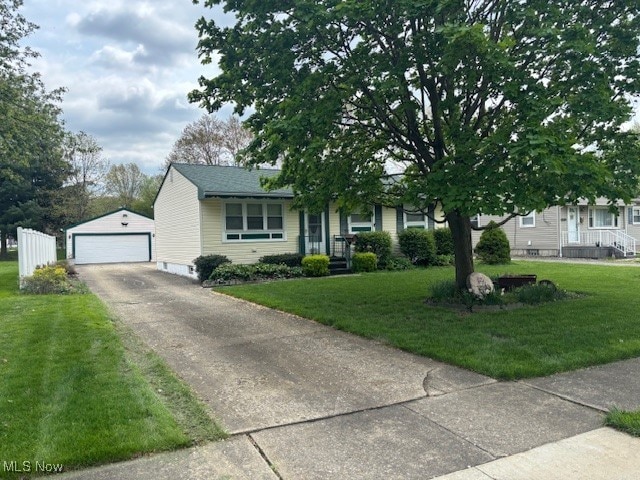obstructed view of property featuring a garage, an outdoor structure, and a front yard