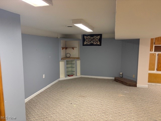 finished basement featuring carpet floors and baseboards