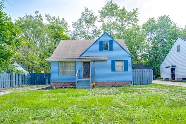 bungalow-style home with roof with shingles and fence